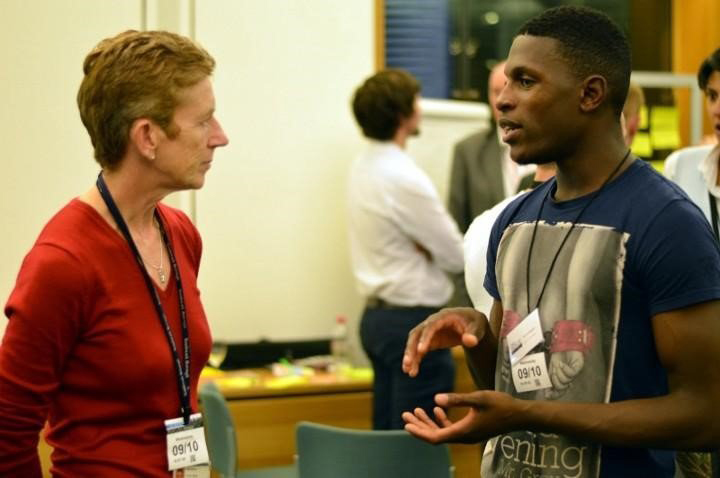 Woman talks to man at a conference
