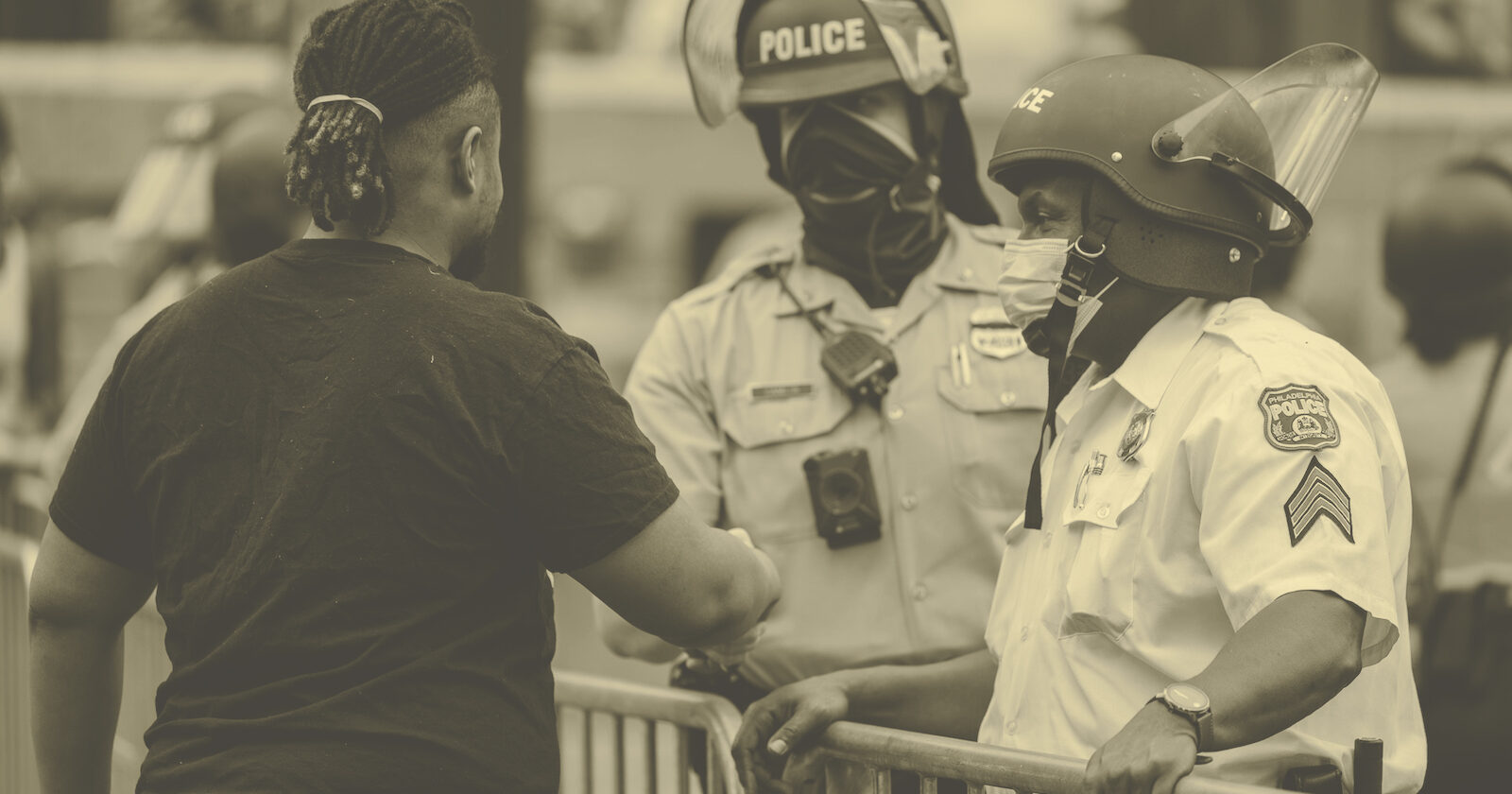 Police officers and protestor talking and shaking hands