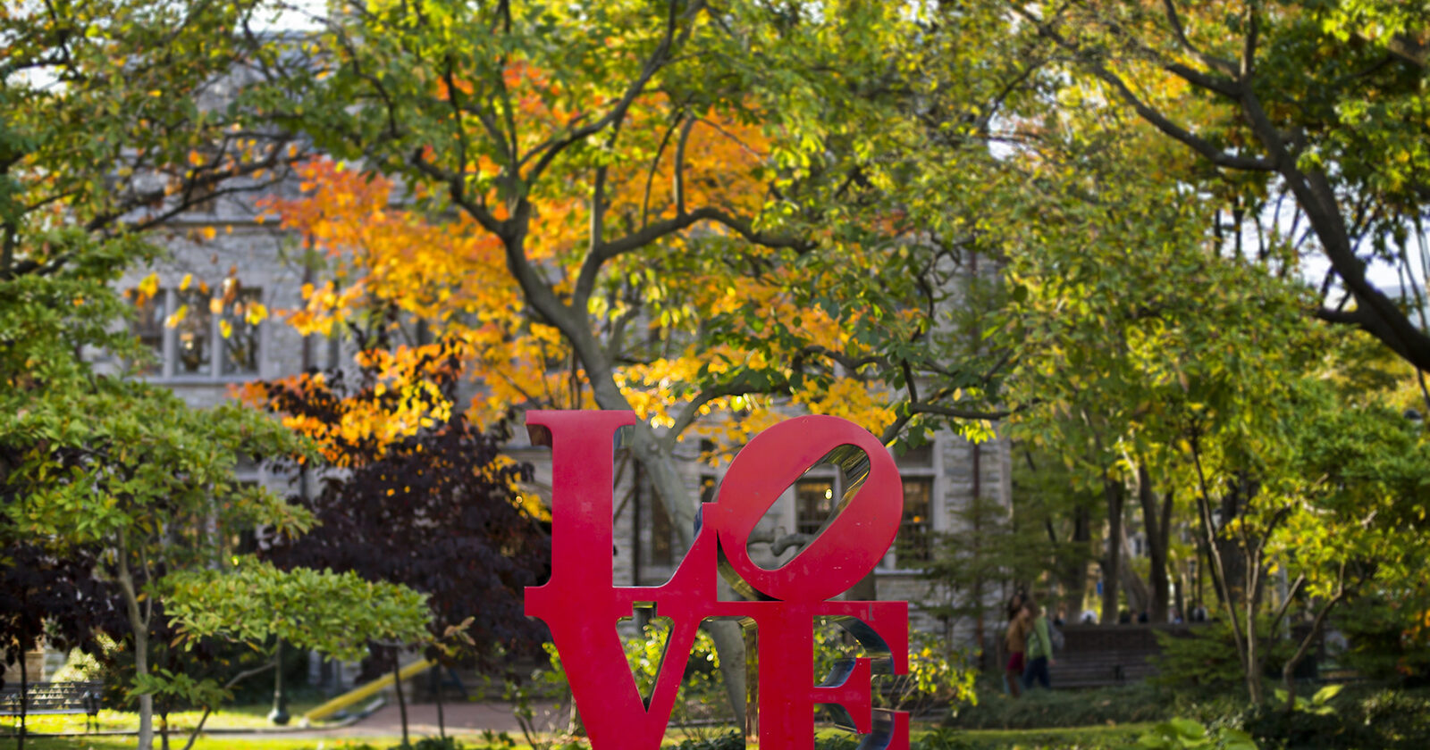 Picture of the Love Statue with greenery in the background