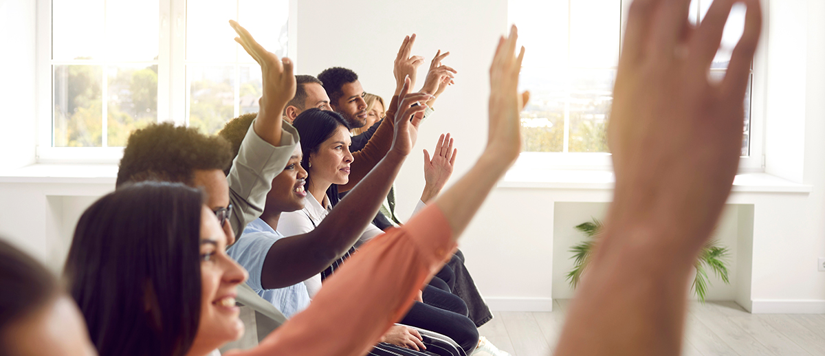 group of people with hands raised