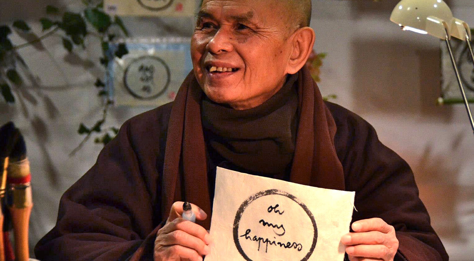 monk holding an ink drawing of a circle