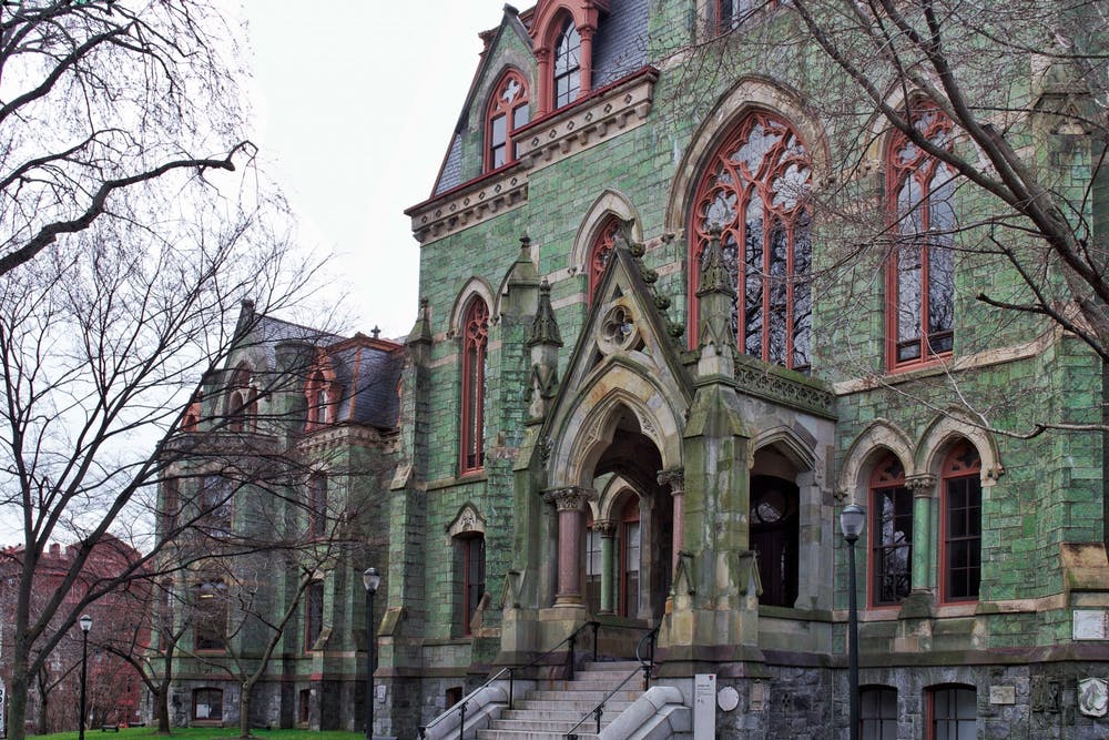 Photo of College Hall which is a green building with red window panes