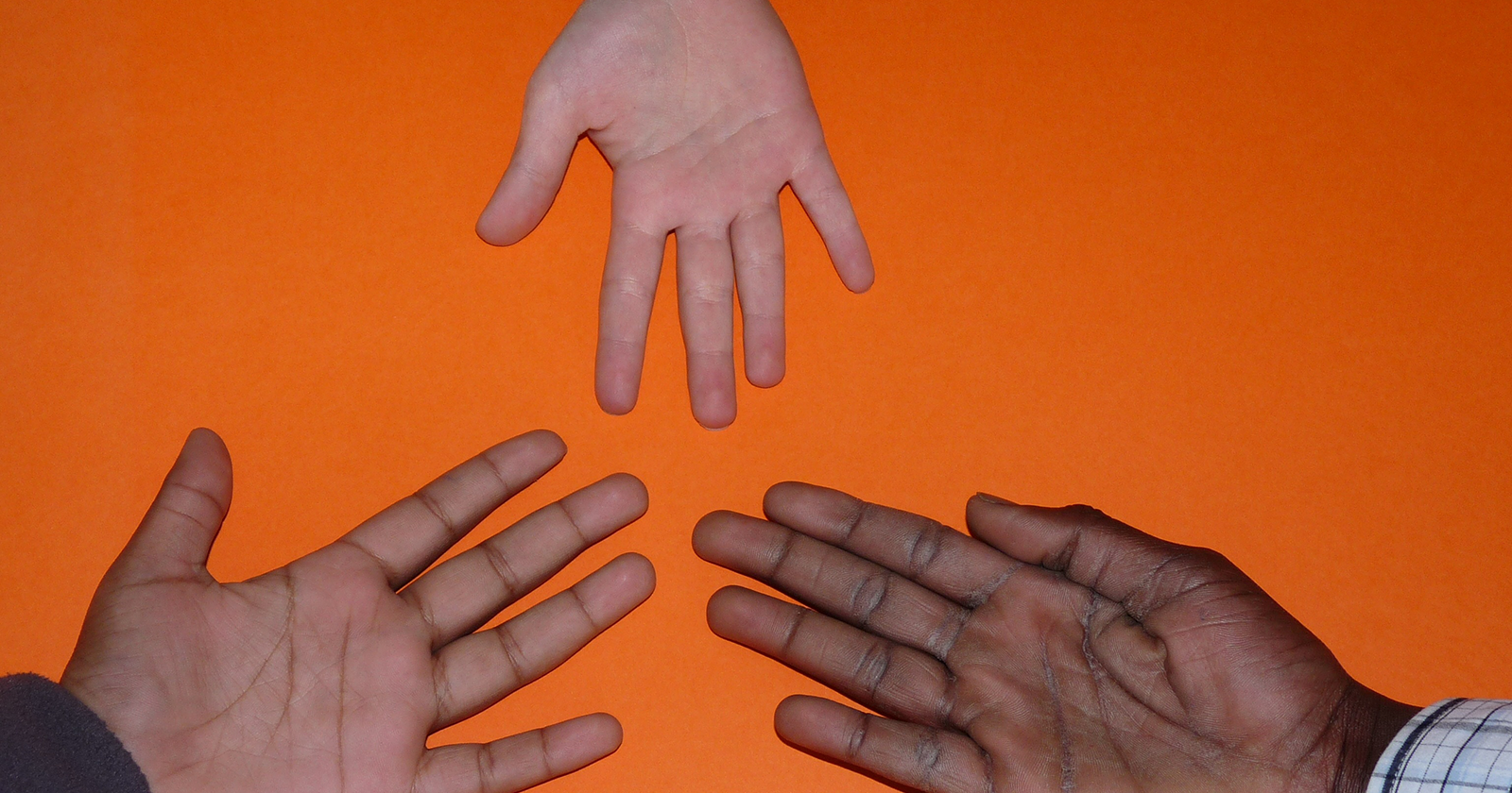 three hands outstretched towards each other