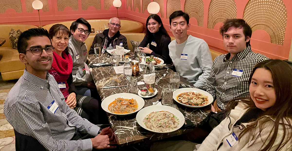 Penn students and faculty at dinner table