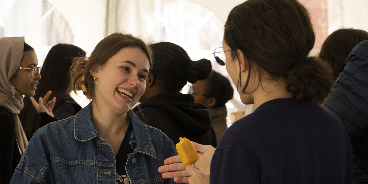 students talking and eating popsicles