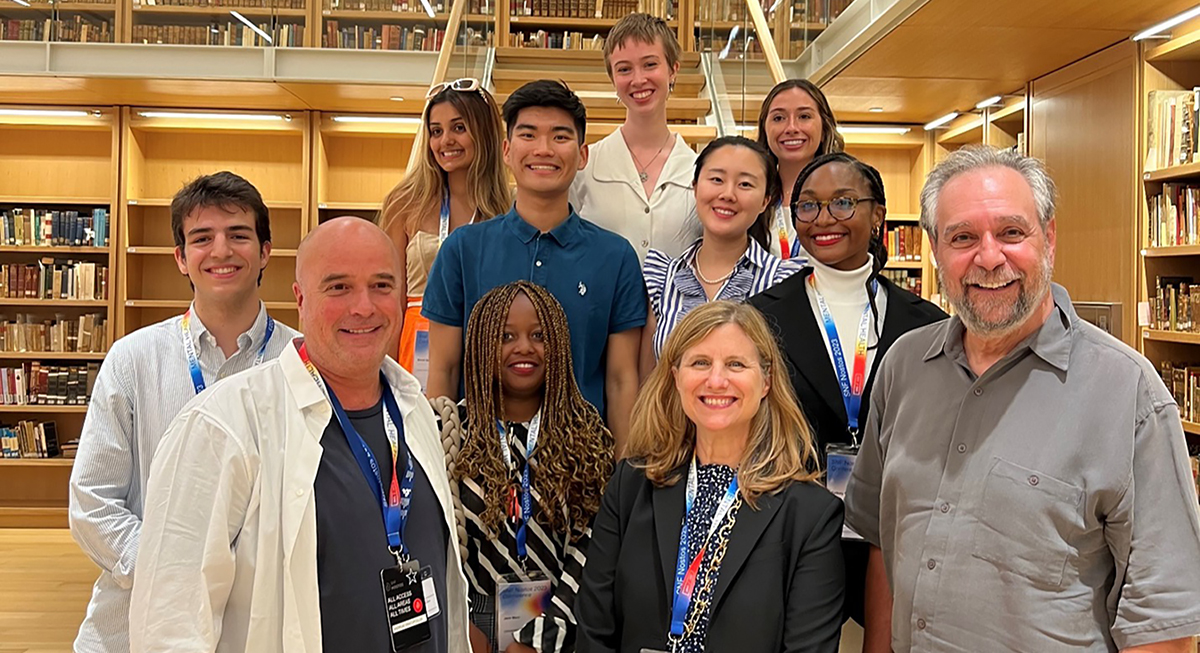 Stavros Niarchos Foundation (SNF) co-president Andreas Dracopoulos, (front left), Penn President Liz Magill (front center), and SNF Paideia founding faculty director Michael X. Delli Carpini (front right) gathered with students and alumni in the rare book collection of the National Library of Greece at the Stavros Niarchos Foundation Cultural Center, as a part of the SNF Nostos Conference, held in Athens in June 2023.