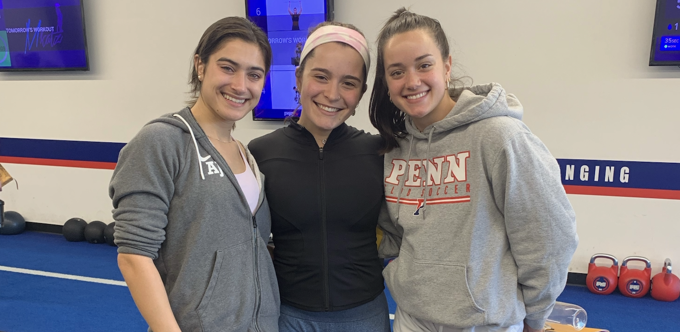 three women facing camera smiling
