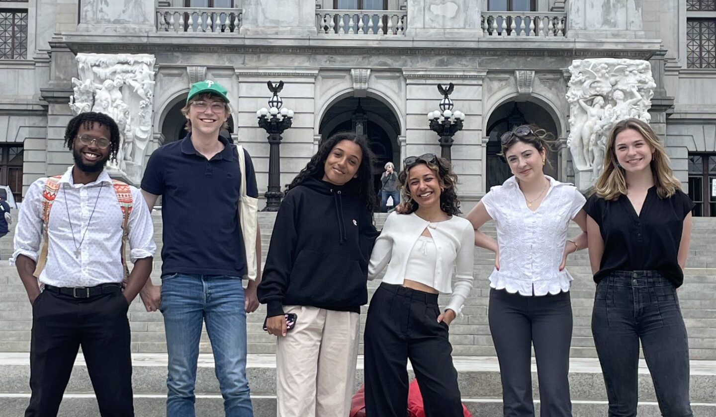 Students standing on the steps of the Capitol building in Harrisburg posing for a group photo