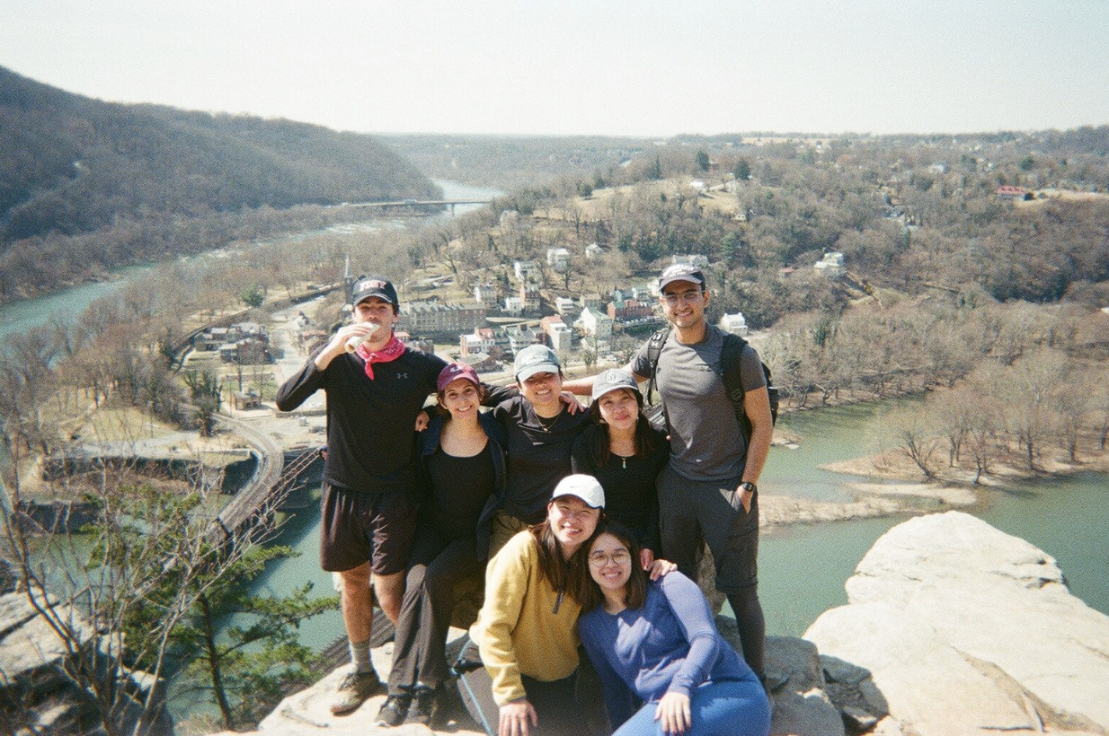 Group photo of seven students on a hike smiling for the camera
